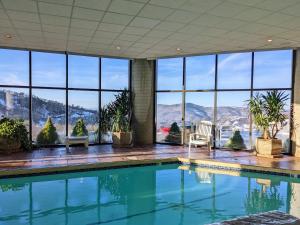 a swimming pool in a house with a view of the mountains at Altitude Adjustment atop Sugar Mountain at Sugar Top in Sugar Mountain