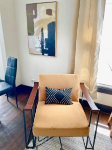 a chair with a pillow on it in a room at Cozy & Stylish Home in Downtown Atlanta in Atlanta