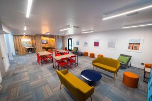 a room with colorful chairs and tables in a building at Sleepover Trendy Downtown Springfield Apartments in Springfield