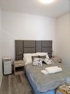 a bedroom with a large bed with two night stands at 2-bedroom security apartment with free parking on premises in Riverwood