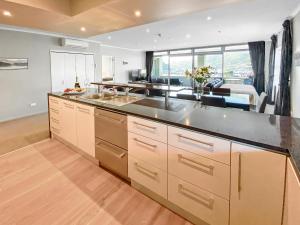 a kitchen with a counter top and a large window at Oxley's Superior Apartment in Picton