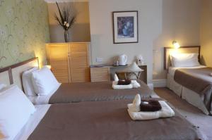 a hotel room with two beds with animals on them at Melbourne Guest House in Rhyl