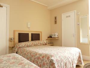 a bedroom with two beds in a room at Melbourne Guest House in Rhyl +18 photos