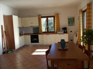 a kitchen with a table and a dining room at Villa Venturelli in Tignale