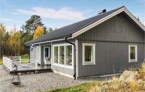 a small grey house with a porch and windows at Gorgeous Home In Hudiksvall With Wifi in Hudiksvall