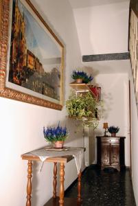 a hallway with a table and a picture on the wall at Da Rina in Mestre