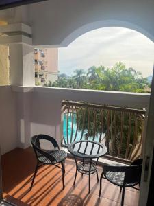 a balcony with chairs and a table and a view of the ocean at D’Alisya Homestay in Tawau