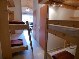 a room with two bunk beds and a sink at Studio Le Grand-Bornand, 1 pièce, 6 personnes - FR-1-458-173 in Le Grand-Bornand