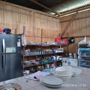 uma cozinha com um balcão com placas e um frigorífico em Filomena Lodge em Ende