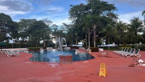 a swimming pool with a fountain in a park at Costa Blanca Villas Lopez in Río Hato