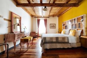 a bedroom with a large bed and a wooden ceiling at Old Town Quito Suites, Heritage Boutique Hotel, Where Every Detail Tells a Story in Quito