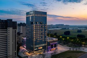 a tall building with lights on in a city at Fairfield by Marriott Liaocheng Dongchangfu in Liaocheng