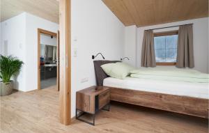 a bedroom with a bed and a window at Moderne Ferienwohnung in Längenfeld +3 photos