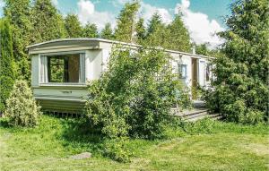 a small house in the middle of a field at Lovely stacaravan In Darlowo With Kitchen in Darłowo