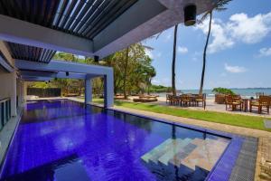 a swimming pool in a house with a view of the ocean at Cocobay Unawatuna in Unawatuna
