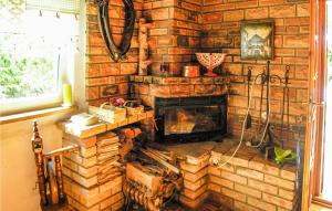 a fireplace in a room with a brick wall at Holiday Home Kaminsko Uljalowcowa in Kamińsko
