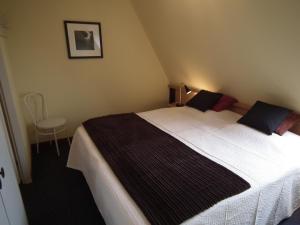מיטה או מיטות בחדר ב-Hollumerstrand