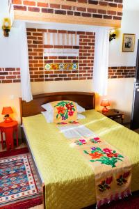 sypialnia z 2 łóżkami i ceglaną ścianą w obiekcie Pensiunea Luna w mieście Buşteni
