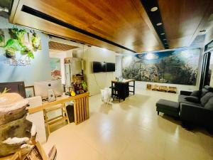 a living room with a large painting on the wall at 浯島文旅WD Hotel in Jinhu