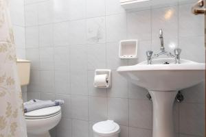 a bathroom with a sink and a toilet at Depis economy apartments in Naxos Chora