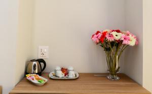 a vase of flowers sitting on a table with a vase of flowers at Dimora del Cuore GUEST HOUSE IN Centro in Vieste +30 photos