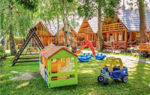 a backyard with play equipment and a log cabin at Awesome Home In Jaroslawiec With Wifi in Jarosławiec