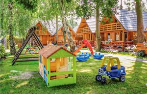 a backyard with play equipment and a log cabin at Nice Home In Jaroslawiec With 2 Bedrooms And Wifi in Jarosławiec