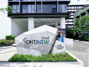 a sign for the entrance to a building at Continew Residences TRX Lux Pool View in Kuala Lumpur