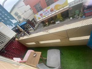 a view of a building with a table and chairs at Danke Hostel in Xiaoliuqiu