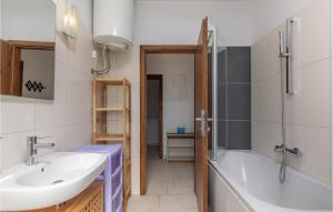 a bathroom with a sink and a bath tub at Cozy Apartment In Njivice With Kitchen in Njivice +16 photos