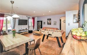 a living room with a ping pong table and a couch at Stunning Home In Montélimar in Montélimar