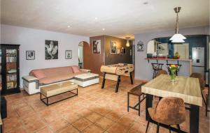 a living room with a couch and a table at Amazing Home In Montlimar With Outdoor Swimming Pool in Montélimar