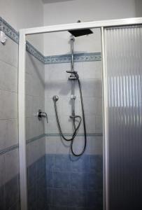 a shower with a hose in a bathroom at Chalet Abetone in Tuscany in Abetone