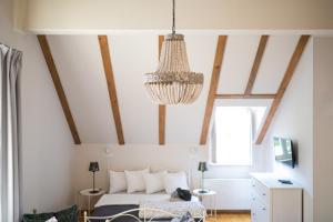 a bedroom with a bed and a chandelier at Paon Boutique Apartments in Zagreb