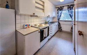 een kleine keuken met een fornuis en een koelkast bij 2 Bedroom Stunning Apartment In sensbruk in Åsensbruk