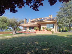 a house with a large lawn in front of it at Resort Orizzonti Glamping in SantʼElpidio a Mare