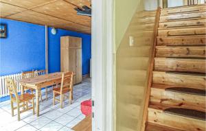 a dining room with a table and a staircase at 2 Bedroom Pet Friendly Home In Legbad in Legbąd