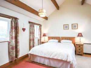 um quarto com uma cama e uma janela em Curlew Cottage em Bromlow
