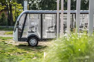 mały biały wózek golfowy zaparkowany na polu w obiekcie Zagaje Pokoje Gościnne w Sarbinowie