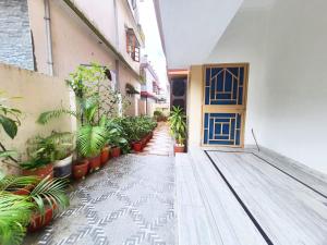 a corridor of a building with a door and plants at Nature View Homestay in Dehradun