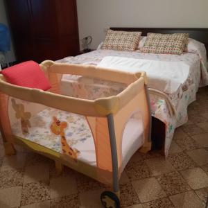 Posteľ alebo postele v izbe v ubytovaní NONNA MARI