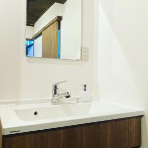 a bathroom with a sink and a mirror at 洲本家　SUMOTOYA in Sumoto