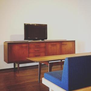 a wooden desk with a tv on top of it at 洲本家　SUMOTOYA in Sumoto