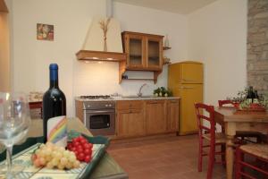 a kitchen with a table with a bottle of wine at Agriturismo La Ronca in San Vincenzo