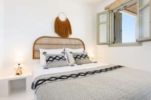 a bedroom with a bed and a mirror on the wall at Parian Philoxenia Villa, Santa Maria Beach in Kampos Paros