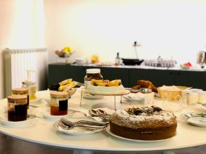 a table with a cake and other food on it at B&B ALIVA in Alcamo