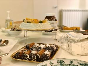 a table with a plate of pastries and a cake at B&B ALIVA in Alcamo