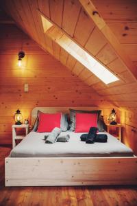 ein Schlafzimmer mit einem großen Bett in einer Holzdecke in der Unterkunft Felusiowa Chata in Laskowa