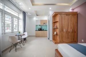 a bedroom with a bed and a table and chairs at Cozrum Homes - Retro House in Ho Chi Minh City