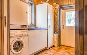 a kitchen with a refrigerator and a washing machine at Lovely Home In Trysil With Wifi in Trysil